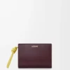Kompakte Geldbörse mit Knotenverschluss aus glänzendem Nappakalbsleder in Dark Burgundy/Light Citrine